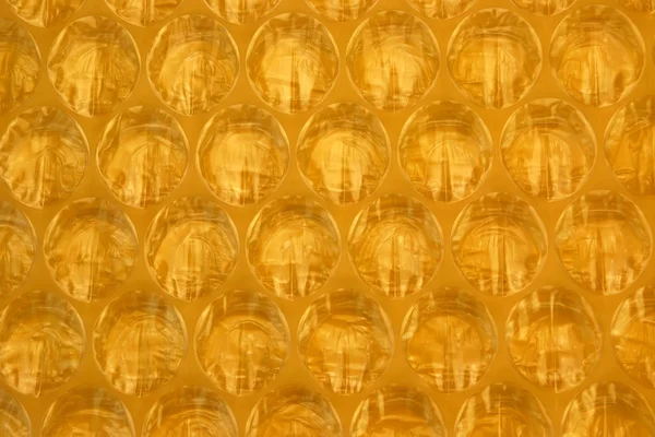 Amber Bubble Wrap Packing Or Air Cushion Film Abstract Backgroun — стоковое фото